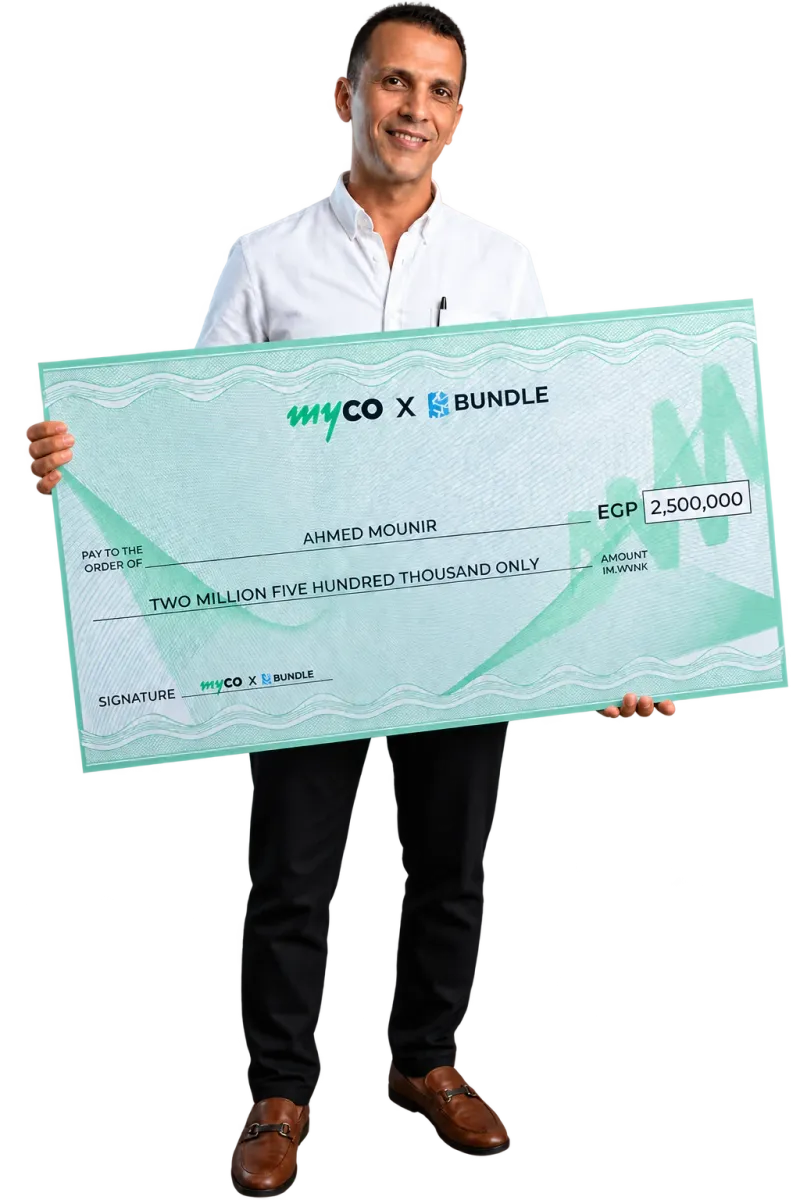 Ahmad Mounir holding his Bundle prize cheque